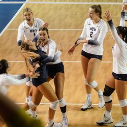BYU players cheer after scoring a point against Utah in an NCAA volleyball game at Smith Fieldhouse in Provo on Saturday, Dec. 4, 2021.
