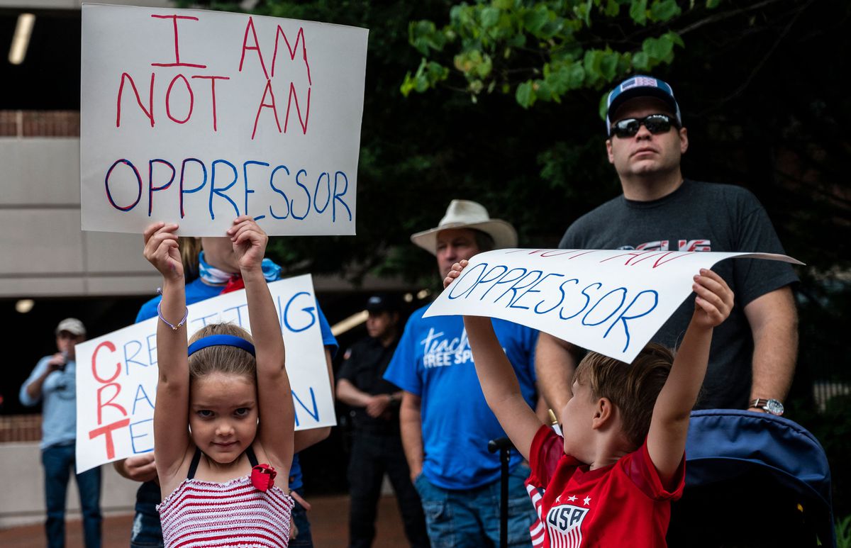 Children hold up signs that read “I am not an oppressor.”