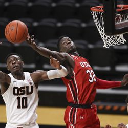 Oregon State’s Warith Alatishe (10) and Utah’s Lahat Thioune (32) reach for a rebound during the first half of an NCAA college basketball game in Corvallis, Ore., Thursday, Feb. 18, 2021.