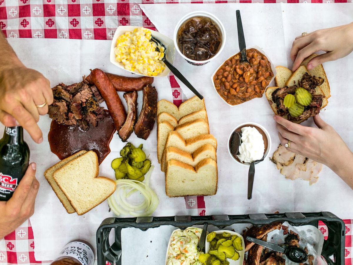A table of meats, breads, and more.