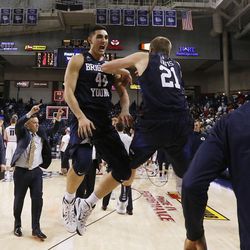 BYU's Corbin Kaufusi (44) and Kyle Davis (21) celebrate after winning an NCAA college basketball game against Gonzaga, Thursday, Jan. 14, 2016, in Spokane, Wash. BYU won 69-68. (AP Photo/Young Kwak)