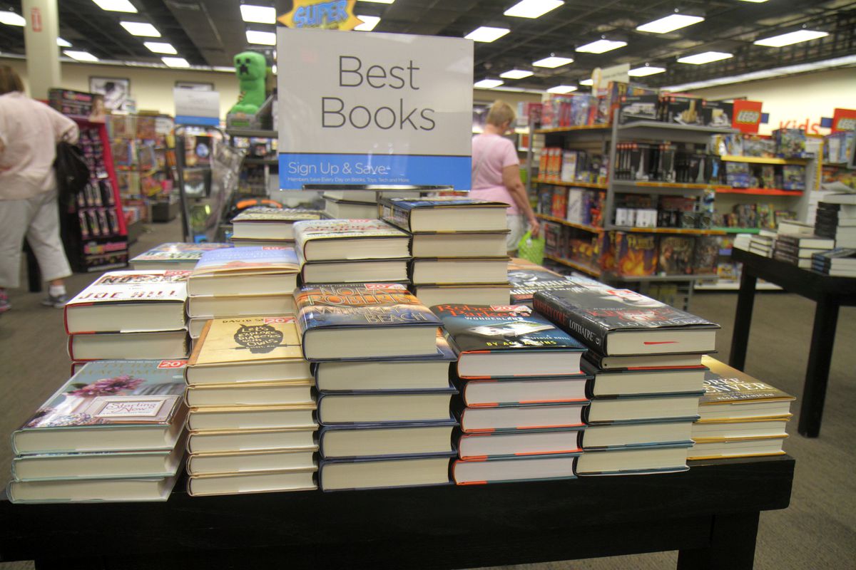 Stacks of new books in a bookstore with the sign “Best books” above them.