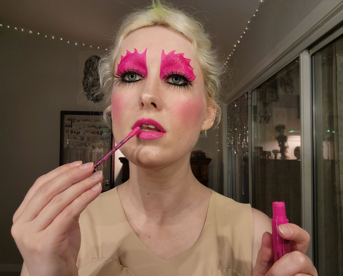 The author putting on pink lipstick