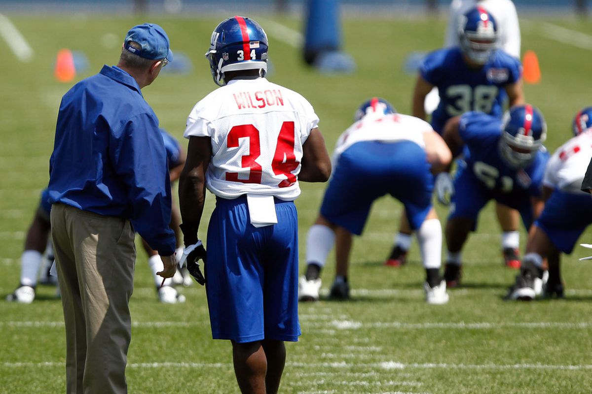 New York Giants first round draft pick running back David Wilson (34) speaks with head coach Tom Coughlin during minicamp at the Timex Performance Center. ebby Wong-US PRESSWIRE
