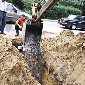 <p>Before the pipe gets covered in dirt, a layer of crushed stone goes in, surrounding the sewer line to stabilize the conduit and help water drain away from it.</p>