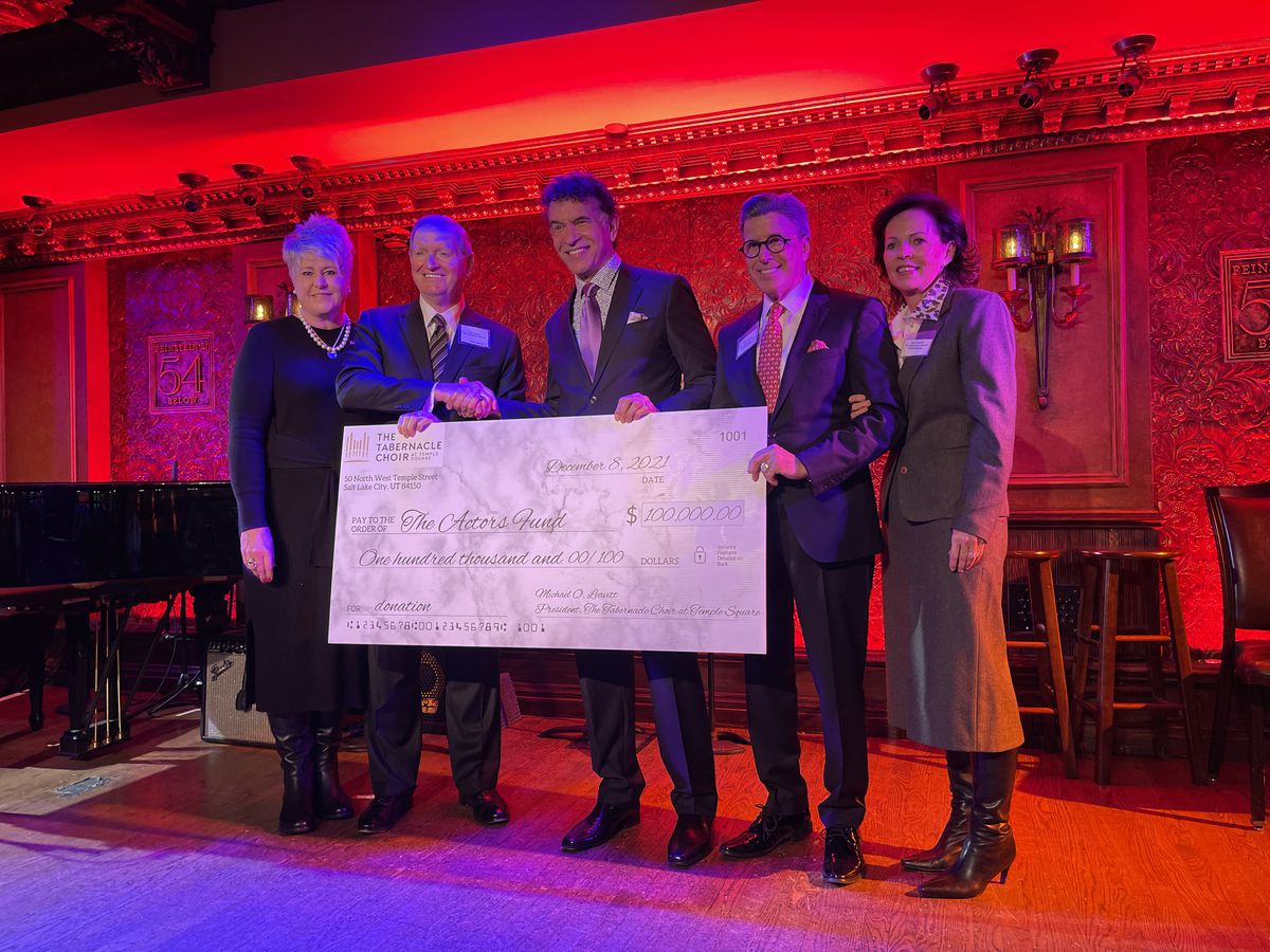 Tony Award winner Brian Stokes Mitchell, center, accepts a $100,000 donation to the Actors Fund from the Tabernacle Choir.