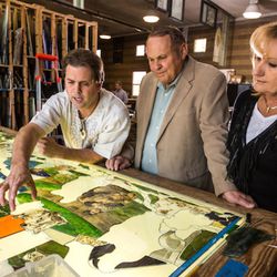 Tom Holdman and Orem philanthropists Marc and Deborah Bingham look at sections of Utah Valley University's 200-foot-long stained glass window installation depicting the history of humanity. The Binghams donated $1.5 million to the project.