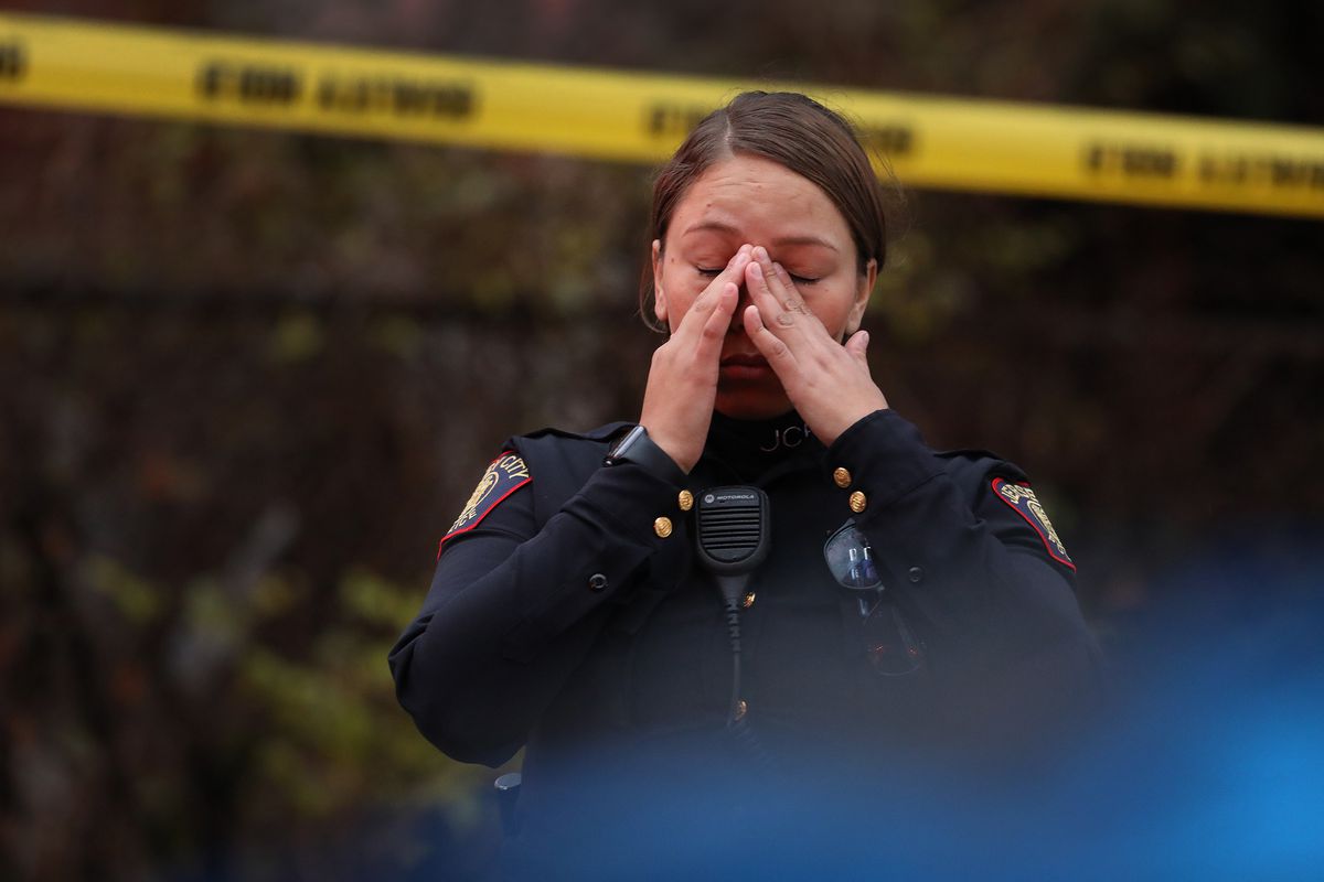 A Jersey City, New Jersey, police officer reacts at the scene of a mass shooting on December 10, 2019.
