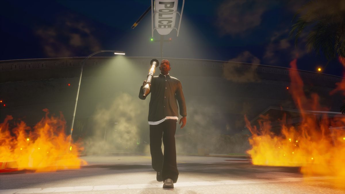 CJ carries a rocket launcher under a police helicopter spotlight in GTA San Andreas from the Grand Theft Auto: The Trilogy — The Definitive Edition release