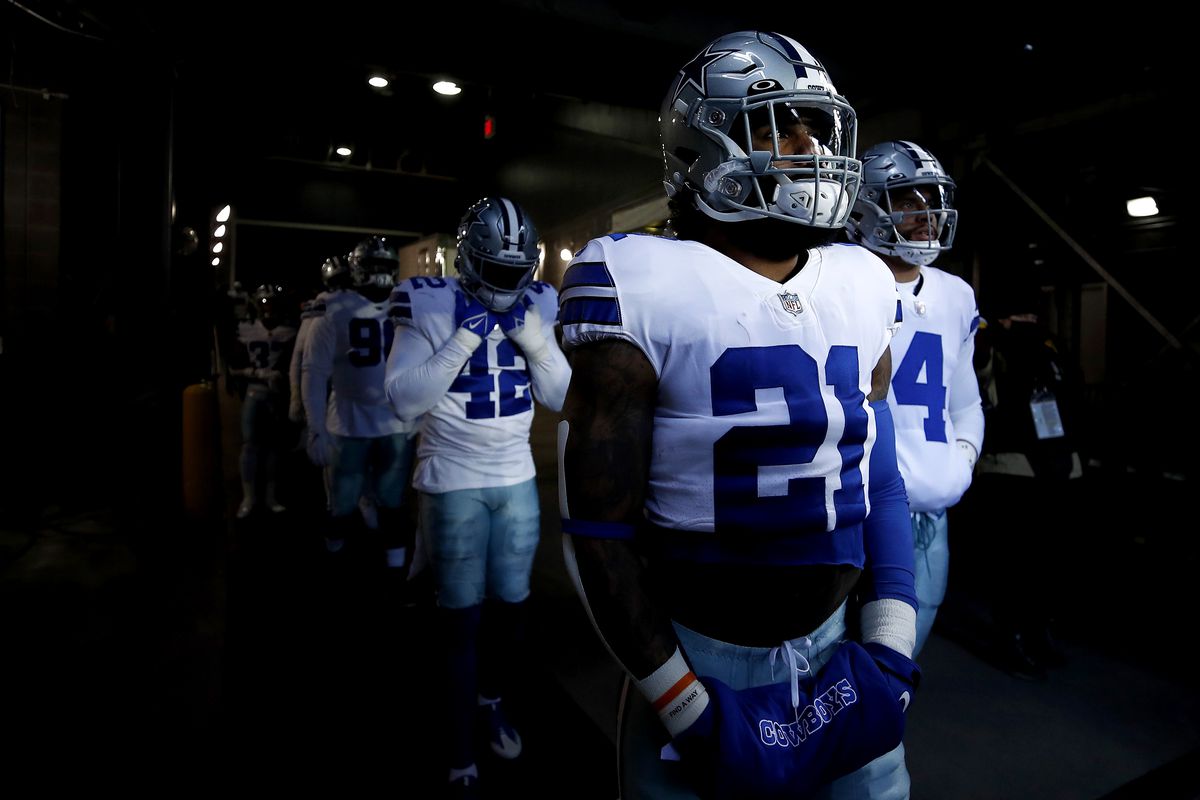 Ezekiel Elliott #21, Dak Prescott #4, and Keanu Neal #42 of the Dallas Cowboys wait in the tunnel before the game against the New York Giants at MetLife Stadium on December 19, 2021 in East Rutherford, New Jersey.