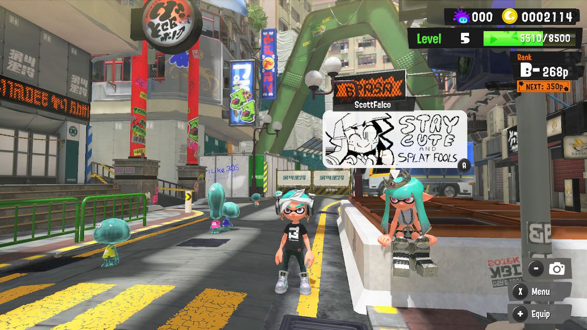 The player hangs out in a lobby in Splatoon 3. Another player’s post is displayed. It features art of their character and reads: “Stay cute and splat fools.”