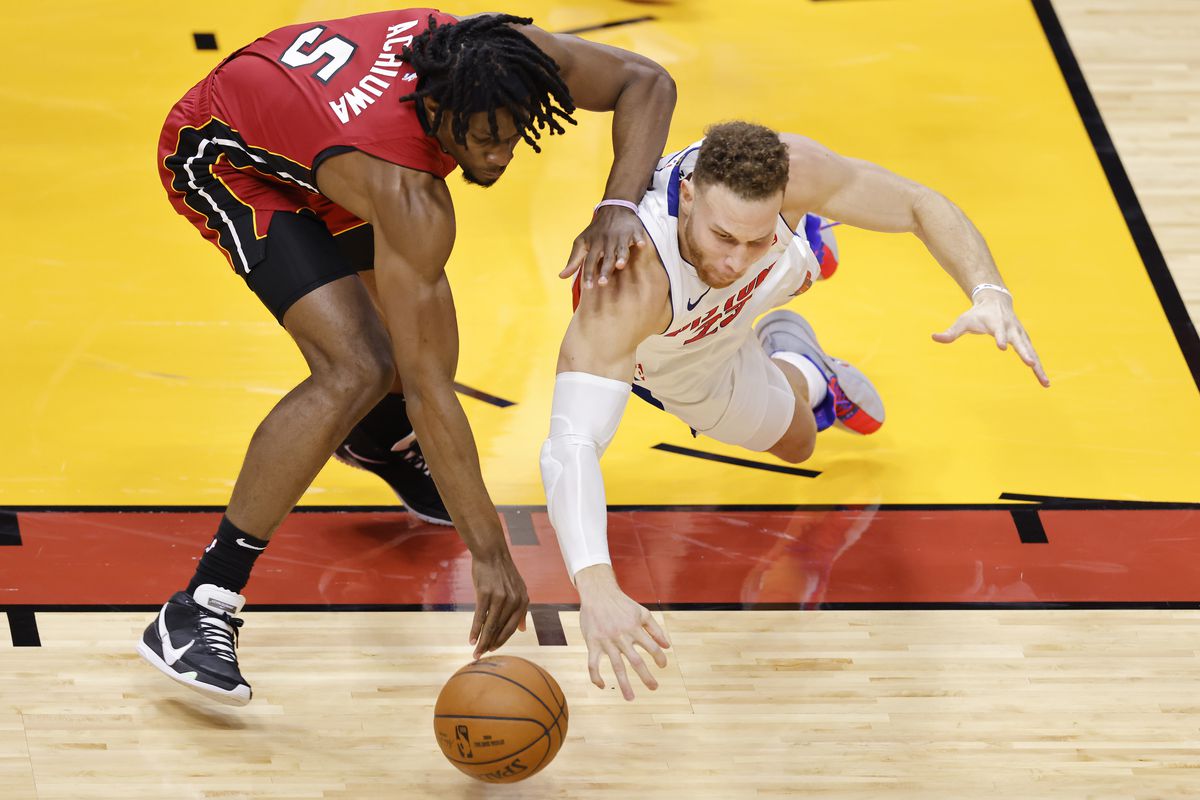 Blake Griffin of the Detroit Pistons and Precious Achiuwa of the Miami Heat battle for a loose ball during the second quarter at American Airlines Arena on January 16, 2021 in Miami, Florida.&nbsp;