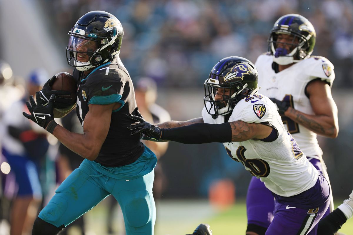 Jacksonville Jaguars wide receiver Zay Jones (7) is shoved out of bounds by Baltimore Ravens safety Geno Stone (26) during the fourth quarter of a regular season NFL football matchup Sunday, Nov. 27, 2022 at TIAA Bank Field in Jacksonville.