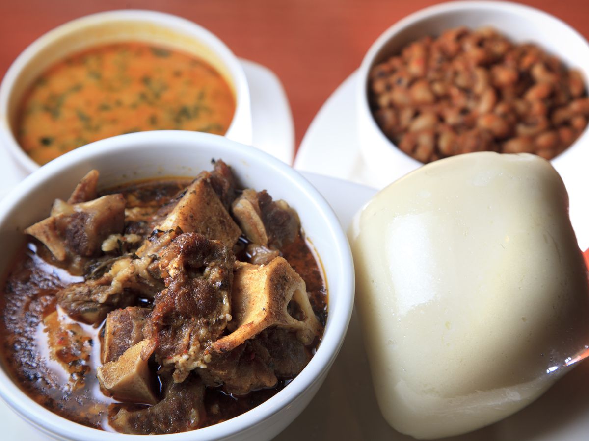 The Oxtail Pepper Stew, $8.75, shown with pounded yam fufu, at right, taushe (peanut soup) at back left, and stewed black eyed peas, back right.&nbsp;