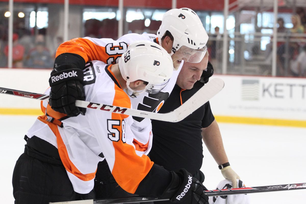 Mark Alt is helped off the ice on Monday.