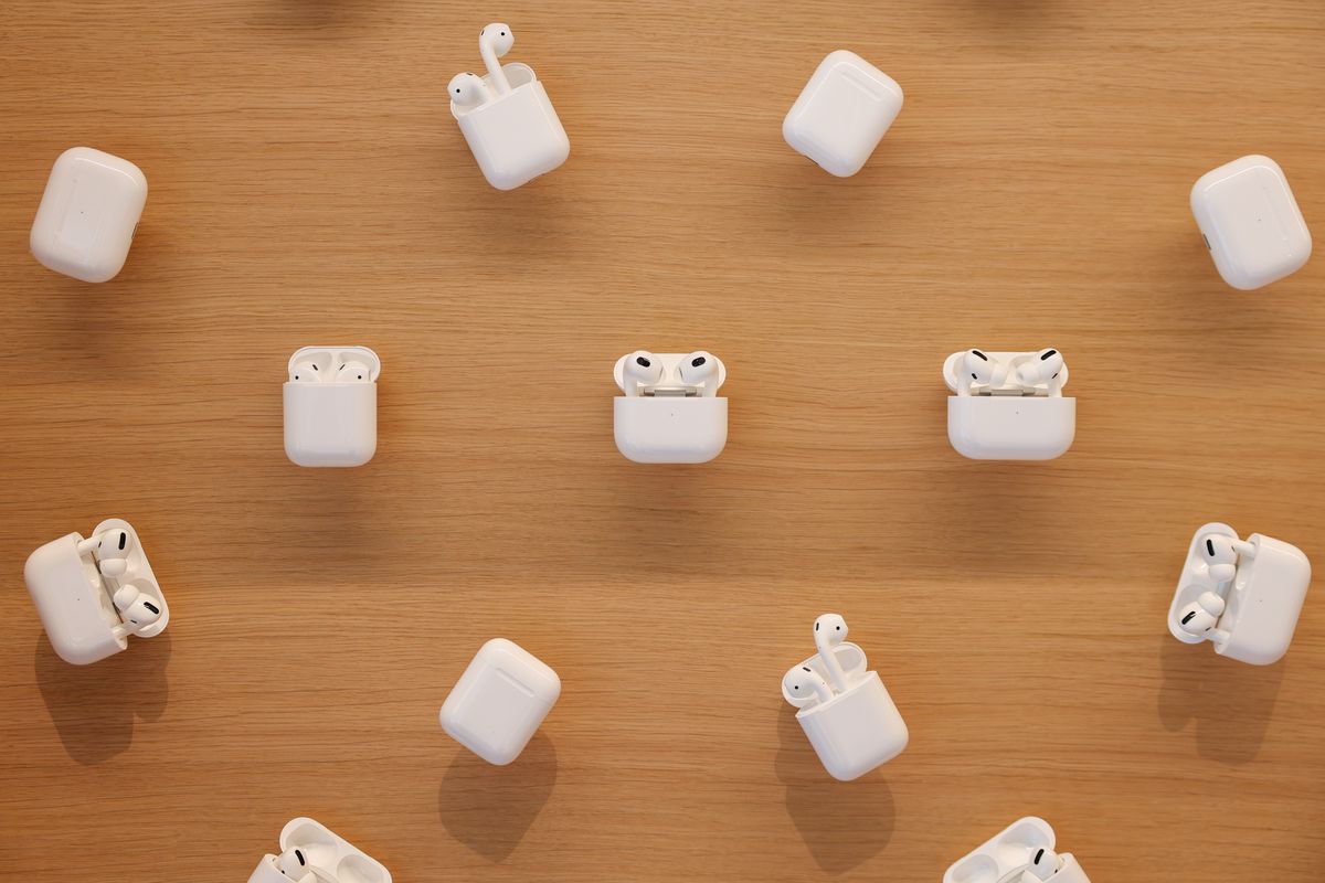 Several sets of AirPods are on display in an Apple Store.