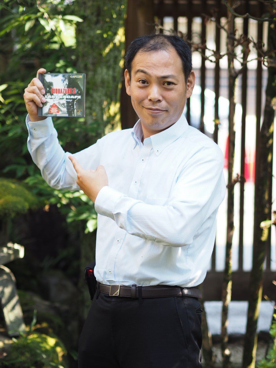Kazuhiro Aoyama holds up a copy of Resident Evil 3