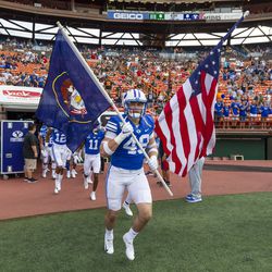 BYU linebacker Payton Wilgar (49) leads his team onto the field for the Hawaii Bowl NCAA college football game against Hawaii, Tuesday, Dec. 24, 2019, in Honolulu.