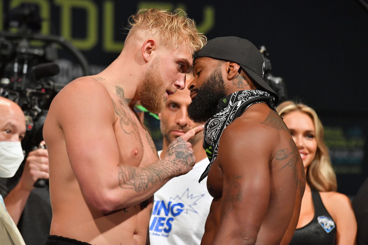 Jake Paul and Tyron Woodley face off during the weigh-ins of their first fight in August. 