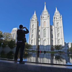 Snapping a photograph of the Salt Lake Temple during the opening session of the 183rd Semiannual  General Conference of the Church of Jesus Christ of Latter-day Saints Saturday, Oct. 5, 2013, in Salt Lake City.  