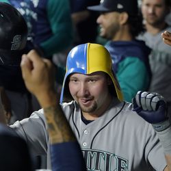 KANSAS CITY, MISSOURI - SEPTEMBER 23: Cal Raleigh #29 of the Seattle Mariners celebrates his home run with teammates in the dugout in the second inning against the Kansas City Royals at Kauffman Stadium on September 23, 2022 in Kansas City, Missouri.