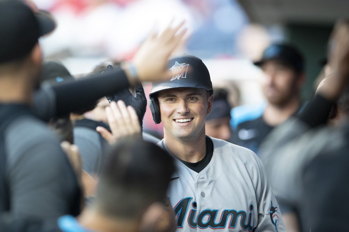 Joe Panik #12 of the Miami Marlins high-fives his teammates after hitting a solo home run in the top of the second inning against the Philadelphia Phillies at Citizens Bank Park