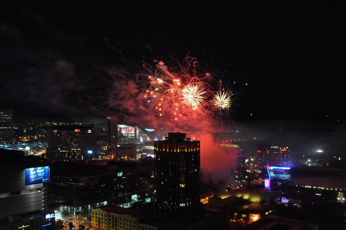 a picture of fireworks exploding over the Atlanta skyline