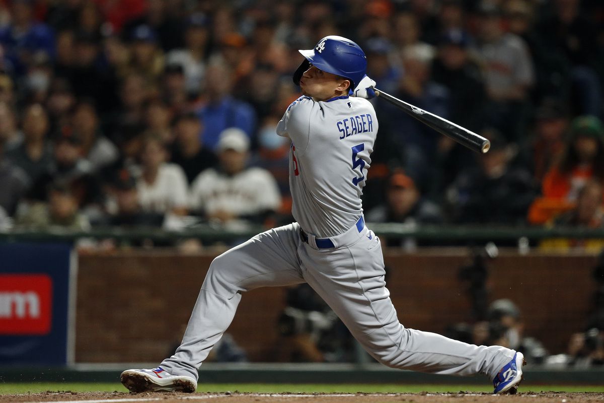 Corey Seager #5 of the Los Angeles Dodgers hits an RBI double in the sixth inning during Game 5 of the NLDS between the Los Angeles Dodgers and the San Francisco Giants at Oracle Park on Thursday, October 14, 2021 in San Francisco, California.