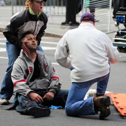 In this photo provided by The Daily Free Press and Kenshin Okubo, people assist an injured after an explosion at the 2013 Boston Marathon in Boston, Monday, April 15, 2013. Two explosions shattered the euphoria of the Boston Marathon finish line on Monday, sending authorities out on the course to carry off the injured while the stragglers were rerouted away from the smoking site of the blasts.