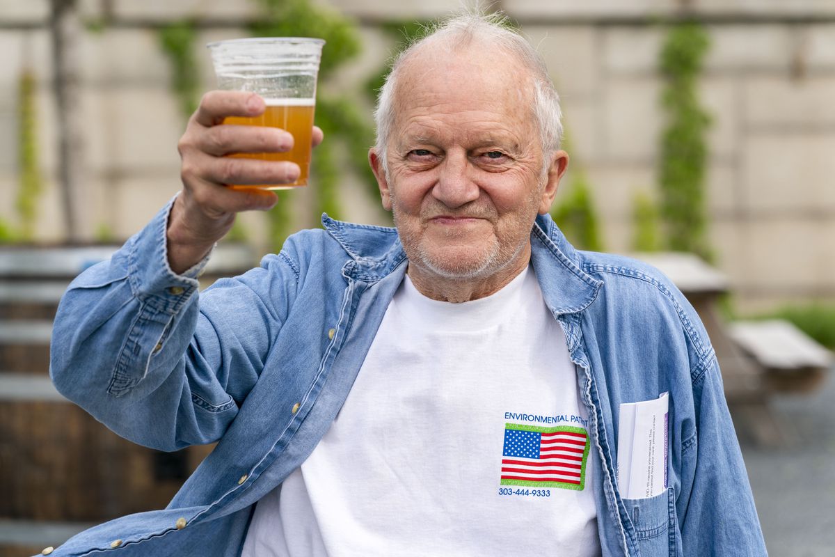 George Ripley, 72, of Washington, holds up his free beer after receiving the J &amp; J COVID-19 vaccine shot earlier this month at the Kennedy Center in Washington.