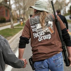 Mark Stewart walks with his wife, Debbie, while carrying an AR-10 rifle during the "March Before Our Lives" rally in Salt Lake City on Saturday, March 24, 2018. The pro-gun march immediately preceded the "March for Our Lives" event, which called for stricter gun control.