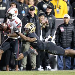 Utah Utes wide receiver Kyle Fulks (6) runs past Colorado Buffaloes defensive back Chidobe Awuzie (4) during the second half of a football game at Folsom Field in Boulder, Colo., on Saturday, Nov. 26, 2016. Utah lost 22-27.