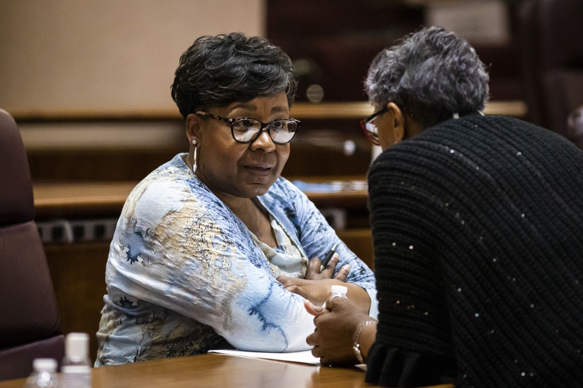 Ald. Michelle Harris (8th) chats with another alderman during a Chicago City Council meeting last month.