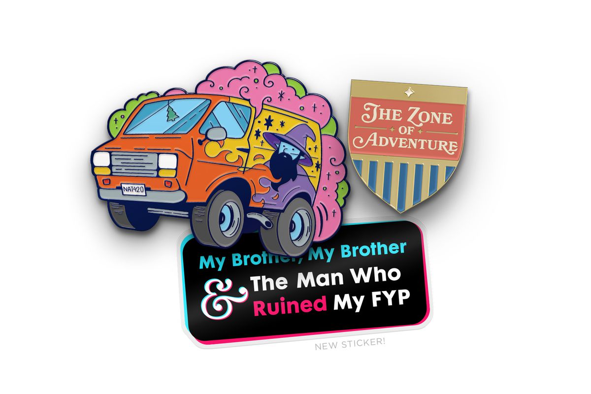 Image of the three December McElroy merch items. On the top left is an enamel pin of a van surrounded by pink and green clouds. The van has a wizard and flames on it. On the top right is an enamel pin of pink and gold shield with blue stripes. It says “The Zone of Adventure”. The bottom center is a black sticker with a pink and blue border that says, “My Brother, My Brother &amp; The Man Who Ruined My FYP”.&nbsp;
