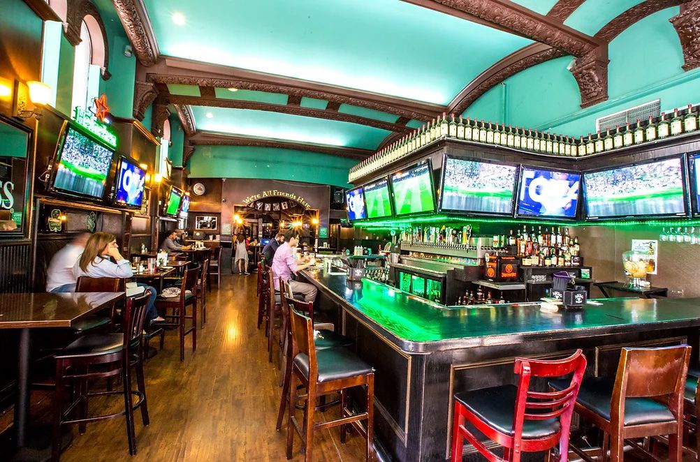 A corner peek at an Irish bar with green painted ceiling.