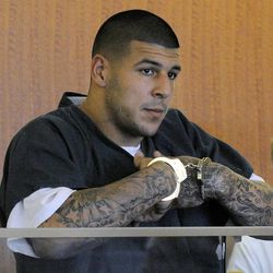 Former New England Patriots football tight end Aaron Hernandez stands during a bail hearing in Fall River Superior Court Thursday, June 27, 2013 in Fall River, Mass. Hernandez, charged with murdering Odin Lloyd, a 27-year-old semi-pro football player, was denied bail. (AP Photo/Boston Herald, Ted Fitzgerald, Pool)