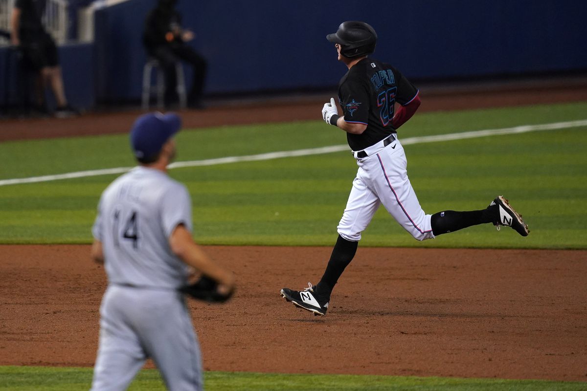Miami Marlins right fielder Garrett Cooper (26) rounds the bases after hitting a solo homerun off of Tampa Bay Rays starting pitcher Rich Hill (14) in the 3rd inning at loanDepot park.