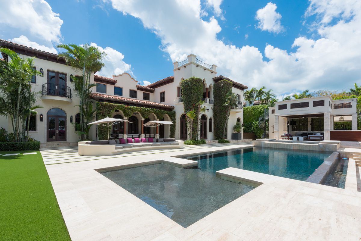 Backyard view of a massive Mediterranean mansion in Miami Beach