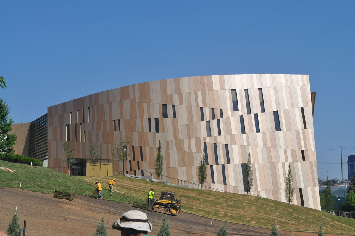 The exterior of the Center for Civil and Human Rights. The facade is tan and white. The building is built into a sloped hill. 