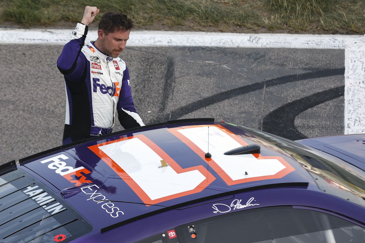 Denny Hamlin, driver of the #11 FedEx Express Toyota, celebrates after winning the NASCAR Cup Series Advent Health 400 at Kansas Speedway on May 07, 2023 in Kansas City, Kansas.