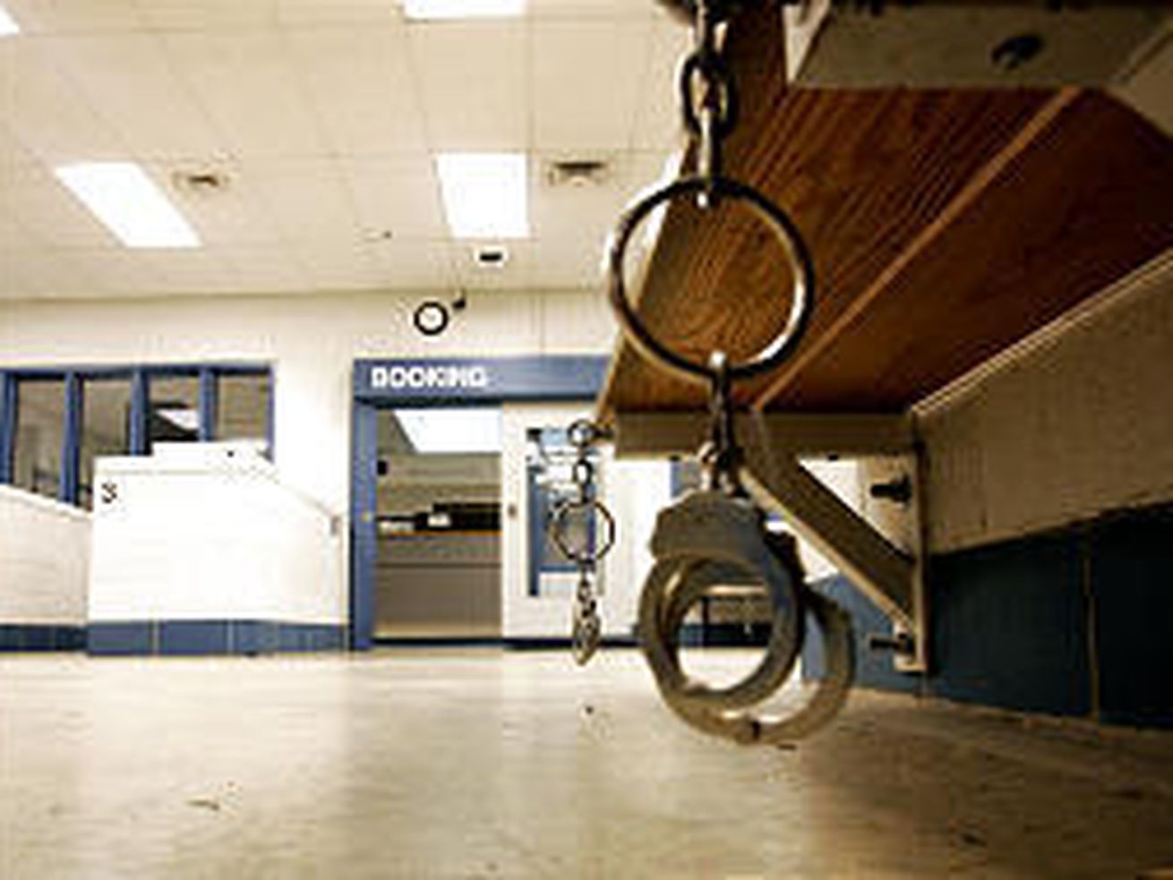 Handcuffs hang from a bench in the pre-booking area of the Utah County Jail, where suicides are increasing.