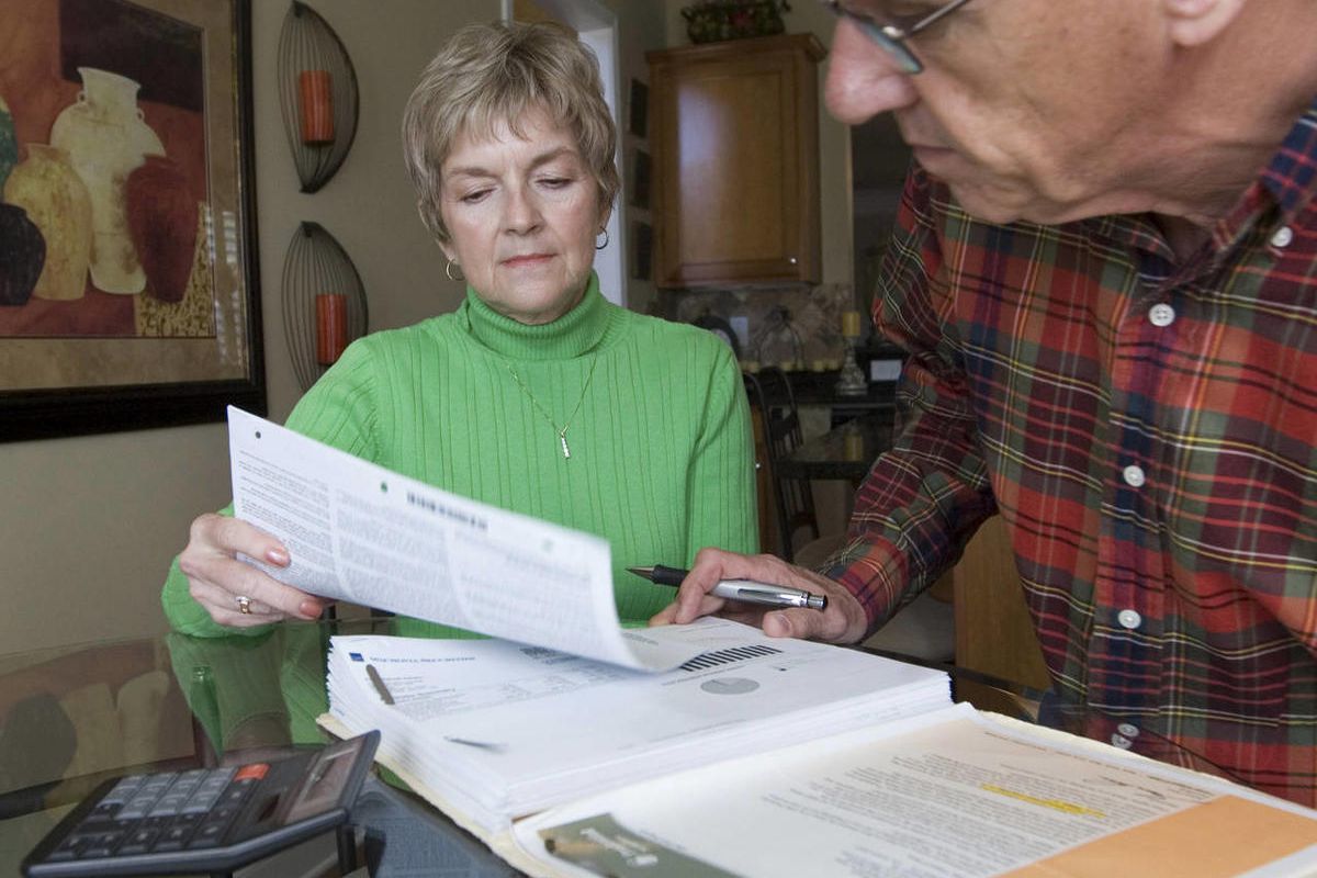 Judy and Bob Dienell review their financial statements  Saturday, Oct. 25, 2008, in Braselton, Ga. 