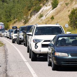 Traffic moves toward Alpine, Wyoming, along Palisades Reservoir, Idaho, after a total eclipse of the sun on Monday, Aug. 21, 2017.