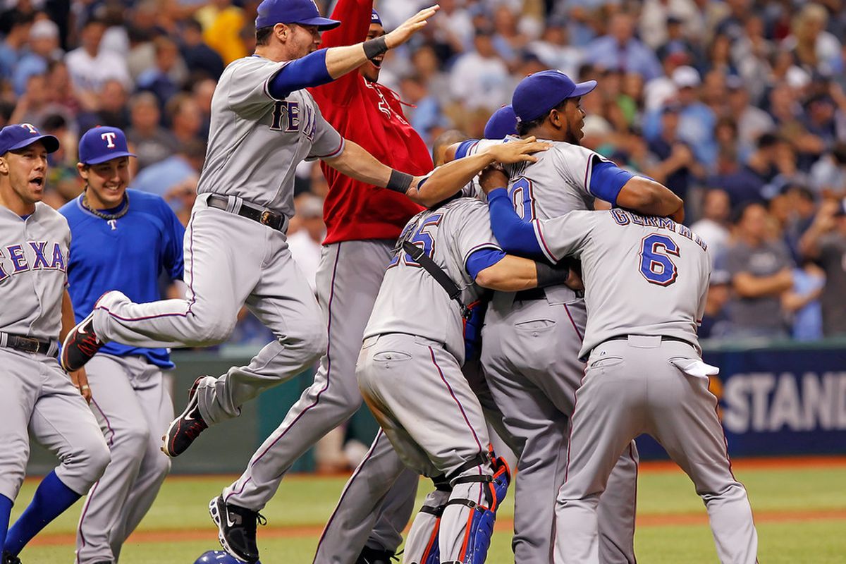 ST PETERSBURG, FL - OCTOBER 04:  The Texas Rangers celebrate their victory over the Tampa Bay Rays in Game Four of the American League Division Series at Tropicana Field on October 4, 2011 in St. Petersburg, Florida.  (Photo by J. Meric/Getty Images)