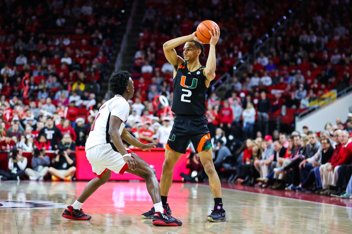 Miami Hurricanes guard Isaiah Wong (2) with the ball looks for his teammates while being defended by North Carolina State Wolfpack guard Jarkel Joiner (1) during the second half at PNC Arena.