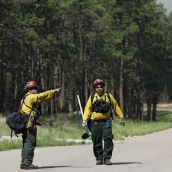 Black Forest Fire Dept. officers examine an evacuated neighborhood, prepping the area for encroachment of the wildfire in the Black Forest area north of Colorado Springs, Colo., on Wednesday, June 12, 2013. The number of houses destroyed by the Black Forest fire could grow to around 100, and authorities fear it's possible that some people who stayed behind might have died. 