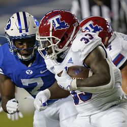 Louisiana Tech running back Justin Henderson (33) carries the ball as BYU defensive back George Udo (7) closes in for the tackle during the first half of an NCAA college football game Friday, Oct. 2, 2020, in Provo. 