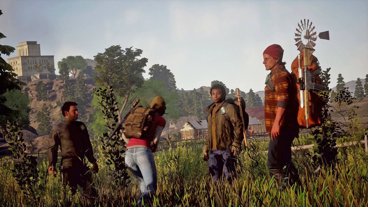 State of Decay 2 - four survivors, all dressed in hardy survival gear, stand in a field. One of them is injured and bending over slightly.