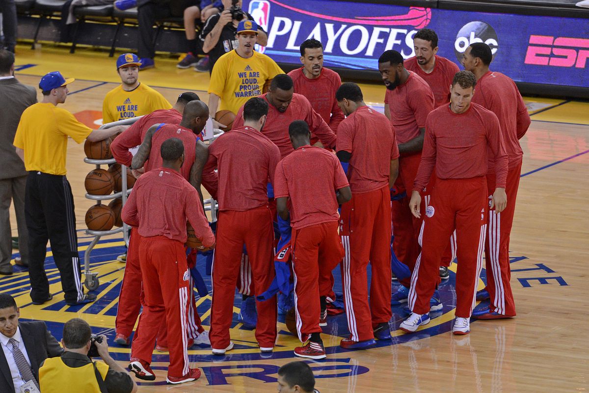 Los Angeles Clippers remove their warm up jackets and wear their shirts inside-out as a sign of protest over the alleged racist remarks made by their owner Donald Sterling before playing the Golden State Warriors in Game 4 of their Western Conference NBA