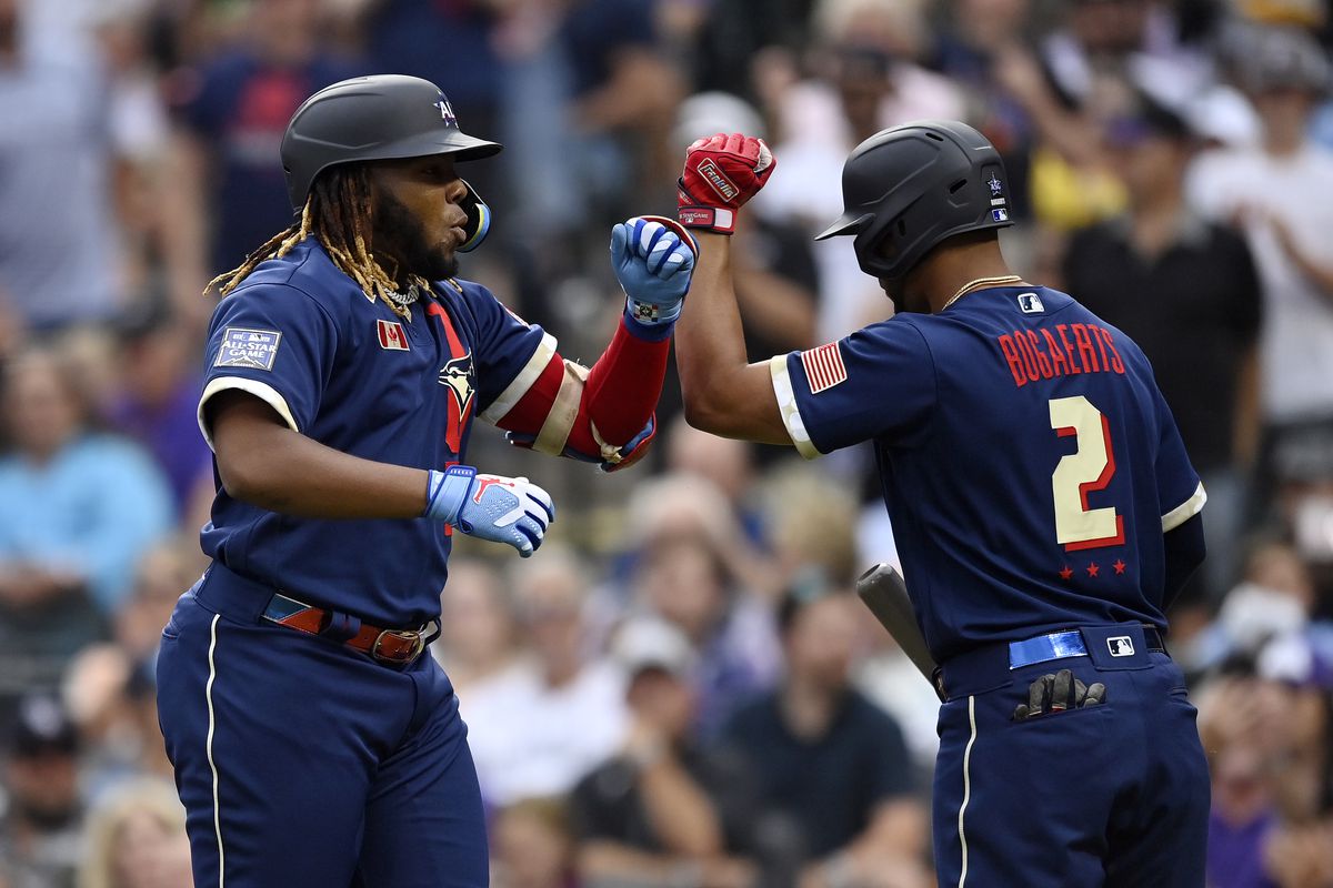 Vladimir Guerrero Jr. #27 of the Toronto Blue Jays celebrates with Xander Bogaerts #2 of the Boston Red Sox after hitting a home run in the third inning during the 91st MLB All-Star Game at Coors Field on July 13, 2021 in Denver, Colorado.